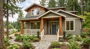 A craftsman house highlighting modern exterior paint trends with olive siding, natural wood pillars, and a blue door.